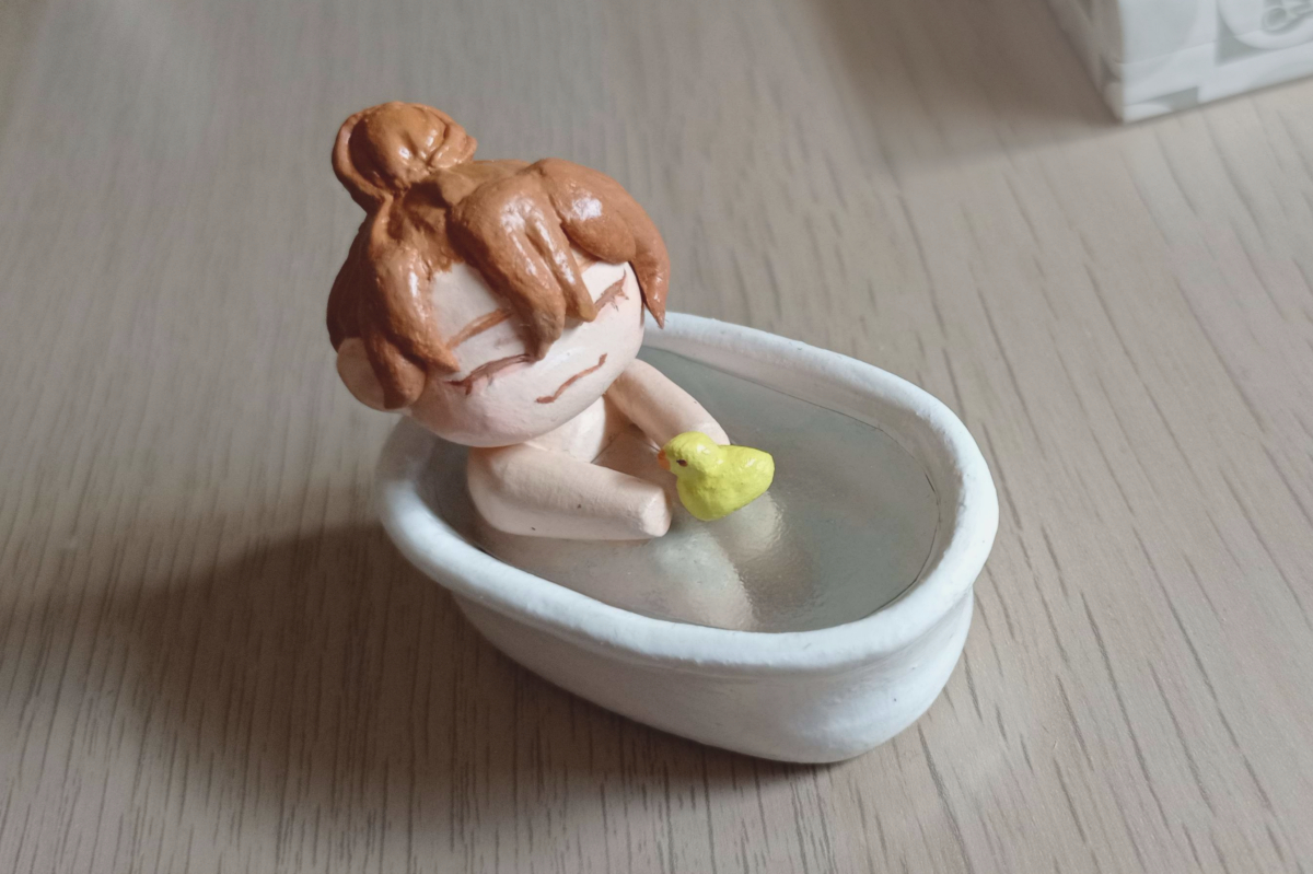 photo of a clay sculpture of Jun taking a bath playing with a rubber duck
